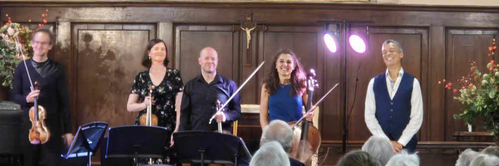 The quartet and Roderick Williams stand in a row at the end of their concert, all with big smiles on their faces