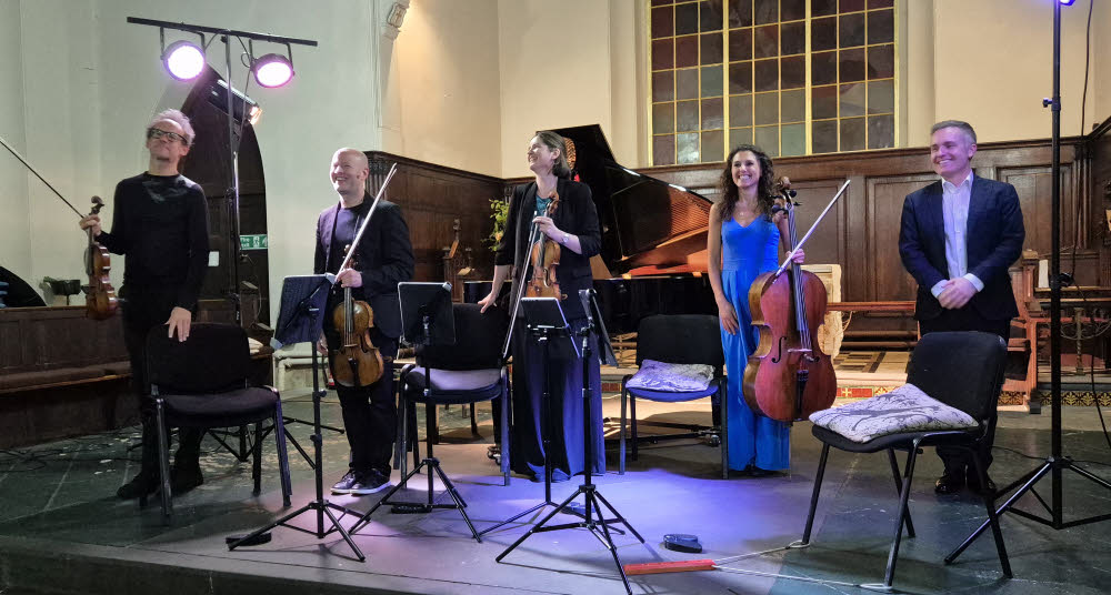 The Carducci String Quartet stand in a row with pianist Simon Callaghan whilst enjoying well-deserved applause