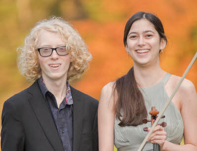 Edward standing with Una, who is holding her violin and bow