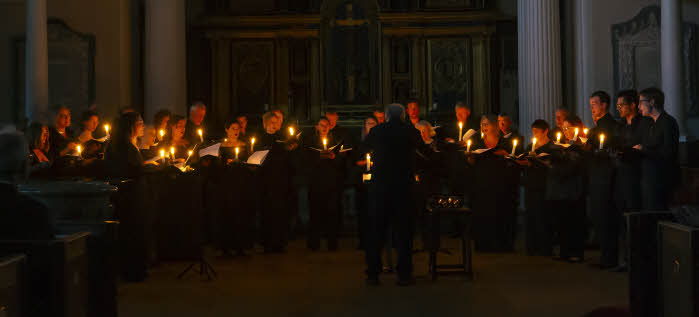 The choir performing by candlelight at the summer 2024 concert