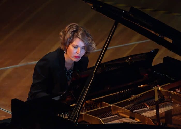 The pianist in concert, viewed from slightly above and showing the open piano top.